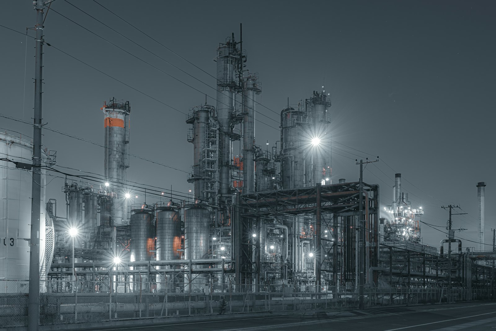 Chemical plant with piping, columns and lighting at dusk